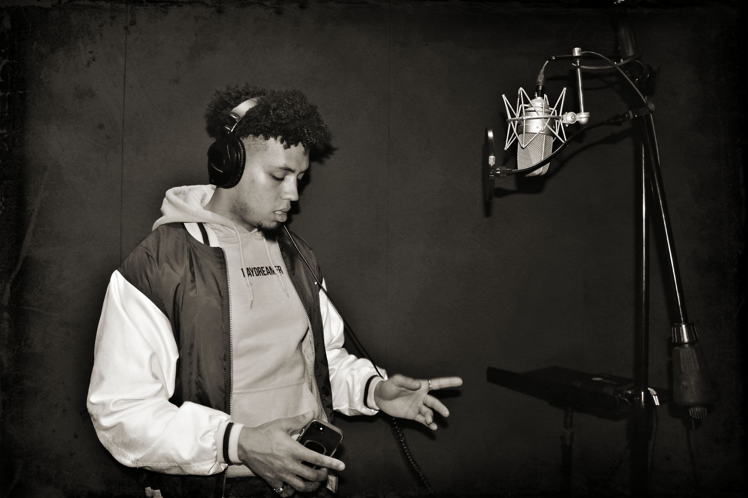 Recording artist performing into a studio microphone