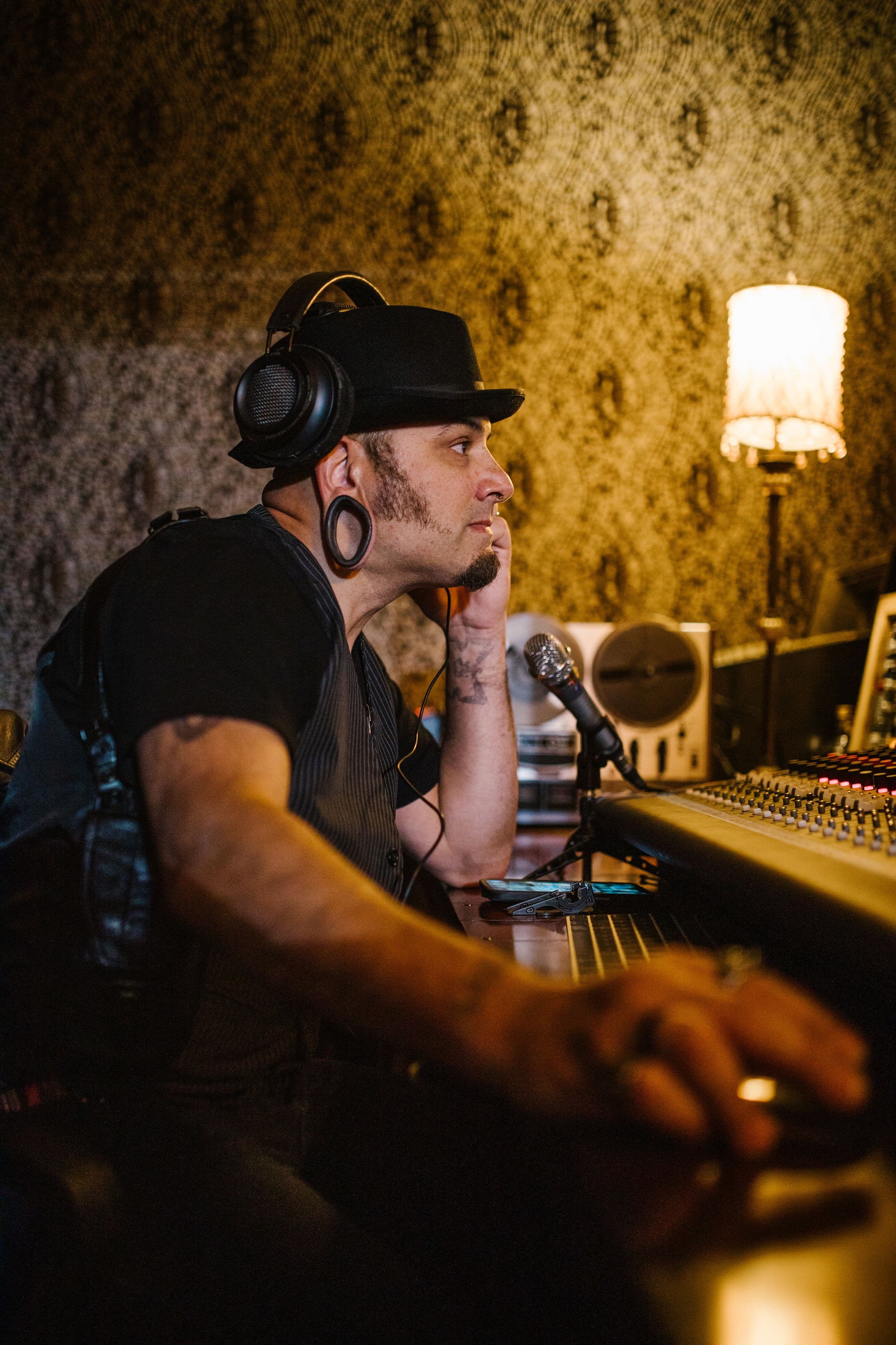 Music producer working at a professional studio mixing console